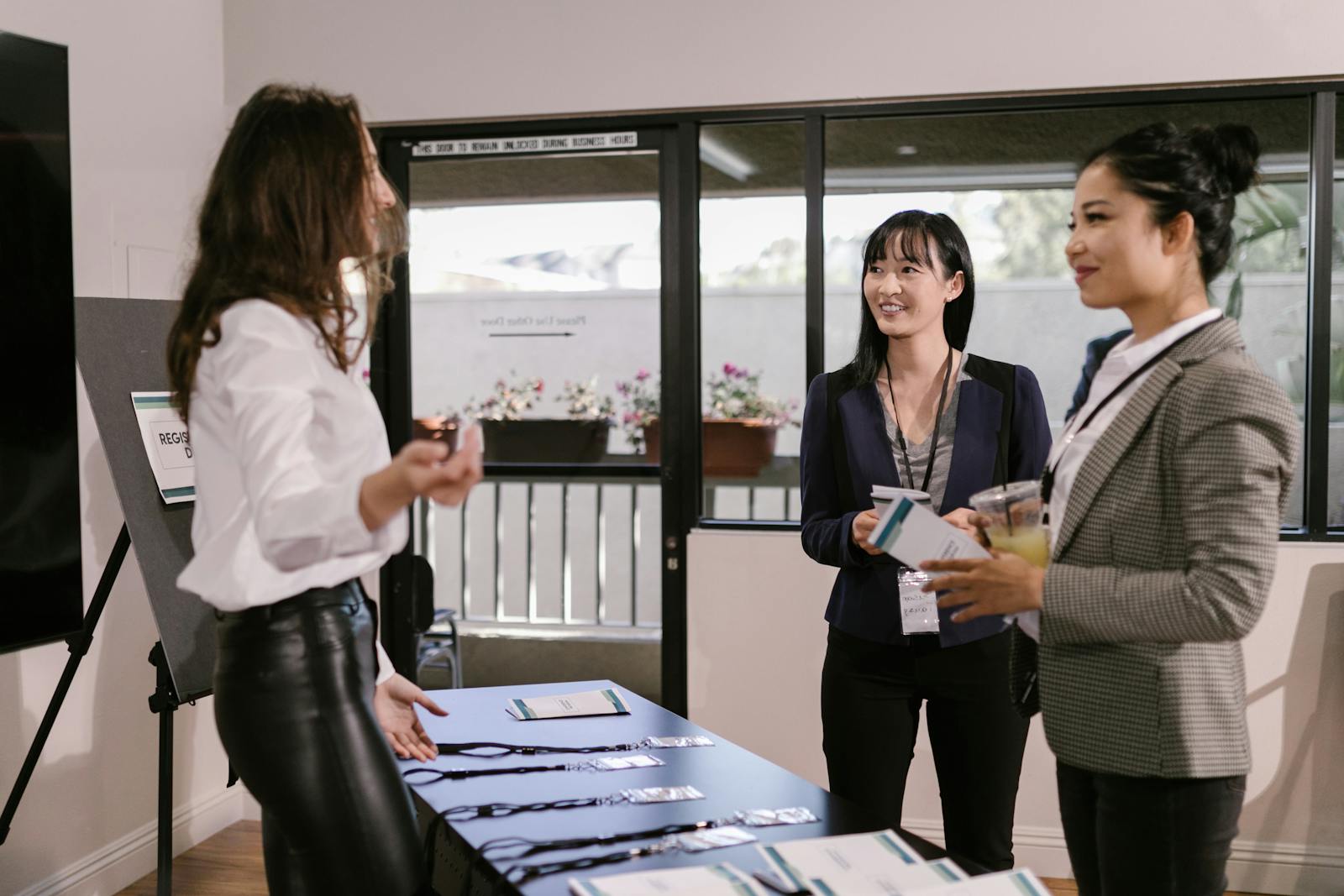 Symposium registration desk with name badges and printed programmes